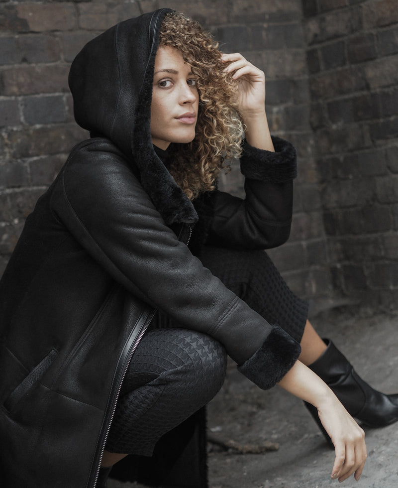 Shearling leather hooded coat in black